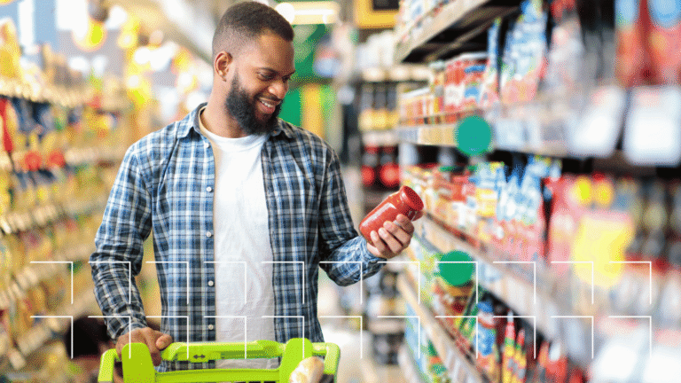 Shopper examining a product on a grocery store shelf, the in-store visit that retail local visibility drives