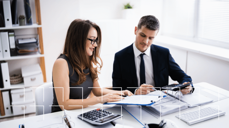 Financial advisor reviewing documents with a client at a branch office, the in-person meeting that local visibility drives