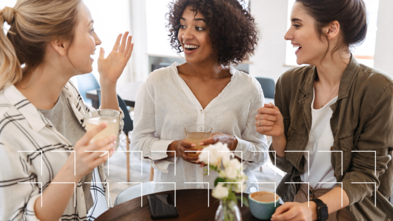 Three guests laughing and chatting over coffee, the kind of local, in-the-moment interaction restaurant social media should capture and share.